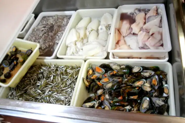 Koeltoog gevuld met zeevruchtne in een visrestaurant te Tajao